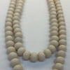 A fashionable and trendy stainless steel necklace with multiple sets of off-white glass beads Application Scenario